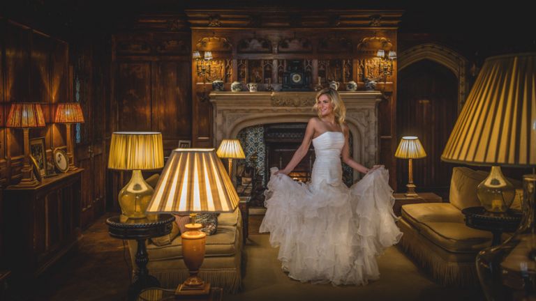 Off camera flash indoors photograph of a bride looking towards the flash. Wedding photography training courses