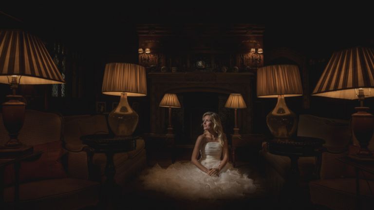 Using LED lighting at weddings, a bridal model looks towards and LED light during a wedding photography training course