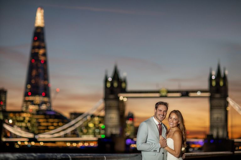 Bride and groom with Tower Bridge in London England. 